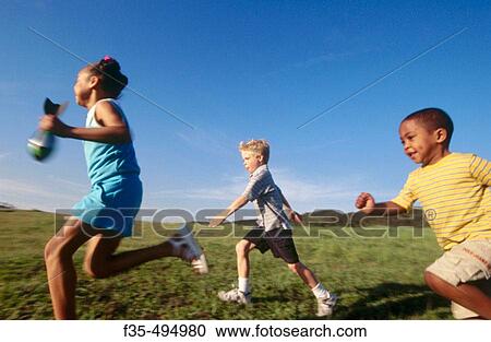 Three kids running in grassy park View Large Photo Image Stock Image - Three kids running in grassy park. Fotosearch
