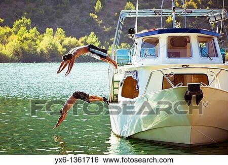 Three men diving into the Krka River in the Krka National Park on a hot summer day in Croatia View Large Photo Image Stock Photograph - Three men diving into the Krka River in the Krka National Park on a hot summer day in Croatia. Fotosearch