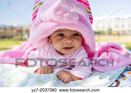 Stock Image - Three Month old baby girl lifting head in park, Bronx, New York, USA.. Fotosearch