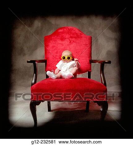 Three-month old boy sitting on red chair wearing neon yellow glasses View Large Photo Image Stock Image - Three-month old boy sitting on red chair wearing neon yellow glasses. Fotosearch