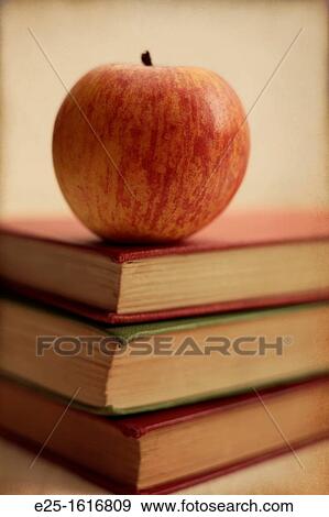 Three old books with a red apple. Slight textured finish. View Large Photo Image Stock Photo - Three old books with a red apple. Slight textured finish.. Fotosearch