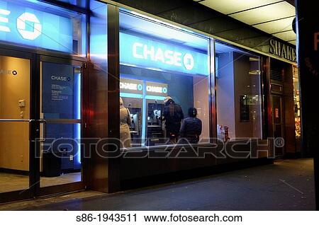 Three People at a Bank Vestibule ATM Machine at Twilight. View Large Photo Image Stock Image - Three People at a Bank Vestibule ATM Machine at Twilight.. Fotosearch
