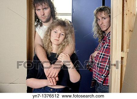 three rather sullen teenagers lounge together in an interior doorway View Large Photo Image Stock Image - three rather sullen teenagers lounge together in an interior doorway. Fotosearch