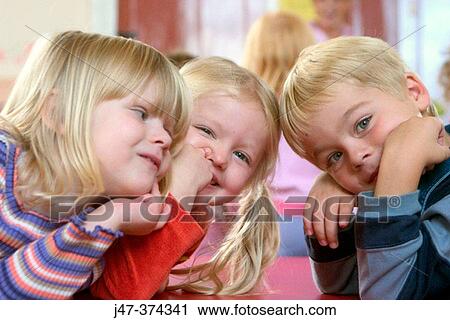 Three small children at nursrey school all leaning on the table, pulling faces at the camera View Large Photo Image Stock Image - Three small children at nursrey school all leaning on the table, pulling faces at the camera. Fotosearch