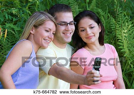 Three taking picture with camera phone View Large Photo Image Stock Image - Three taking picture with camera phone. Fotosearch