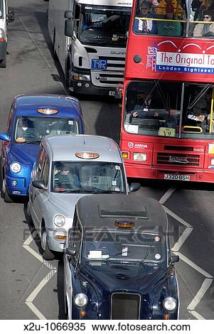 Three taxi cabs in London traffic View Large Photo Image Stock Photography - Three taxi cabs in London traffic. Fotosearch
