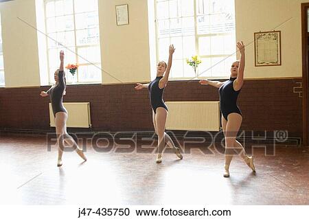 Stock Image - Three teenage ballerinas in dance class. Fotosearch