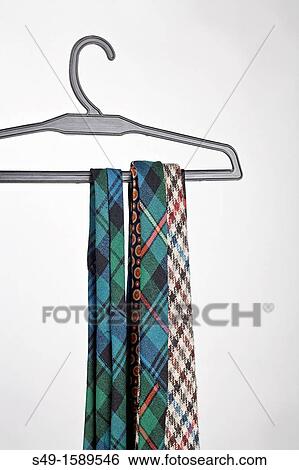 Three tie in a hanger View Large Photo Image Stock Photograph - Three tie in a hanger. Fotosearch
