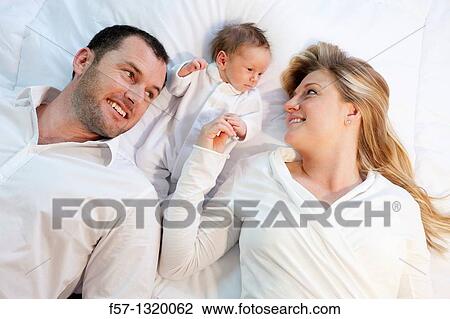 Three week old baby boy with parents. View Large Photo Image Stock Image - Three week old baby boy with parents.. Fotosearch