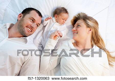 Three week old baby boy with parents. View Large Photo Image Stock Image - Three week old baby boy with parents.. Fotosearch