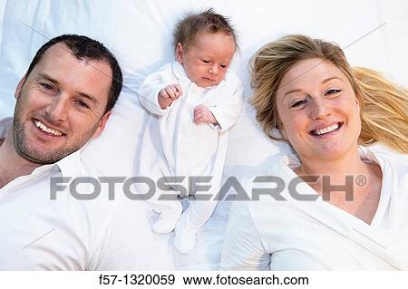Three week old baby boy with parents. View Large Photo Image Stock Photo - Three week old baby boy with parents.. Fotosearch
