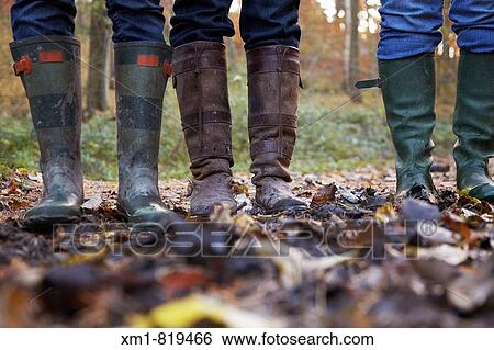 Three women in wellington boots in a forest View Large Photo Image Stock Photograph - Three women in wellington boots in a forest. Fotosearch