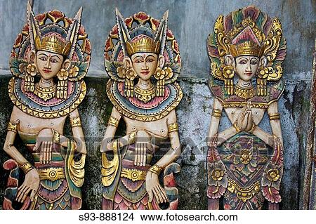Three wooden figures of Balinese dancers in traditional dress in Ubud, Bali. View Large Photo Image Picture - Three wooden figures of Balinese dancers in traditional dress in Ubud, Bali.. Fotosearch