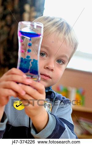 Three year old boy holding a toy at nusrey school View Large Photo Image Stock Photograph - Three year old boy holding a toy at nusrey school. Fotosearch
