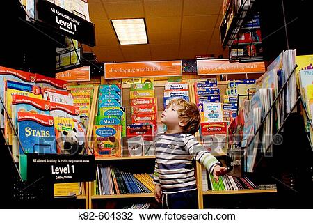 Three year old boy in a bookstore. View Large Photo Image Stock Image - Three year old boy in a bookstore.. Fotosearch