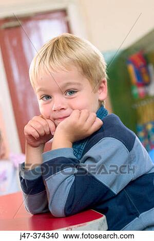 Three year old boy sitting at table View Large Photo Image Stock Image - Three year old boy sitting at table. Fotosearch