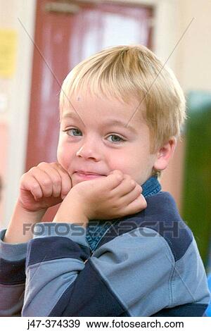 Three year old boy sitting at table View Large Photo Image Stock Photo - Three year old boy sitting at table. Fotosearch