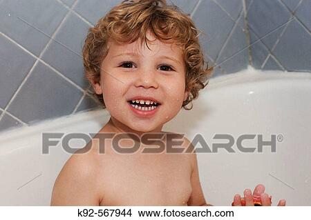 Picture - Three year old boy taking a bath. Fotosearch