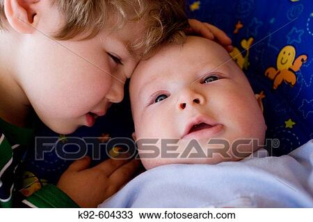 Three year old boy with his four month old baby brother. View Large Photo Image Stock Image - Three year old boy with his four month old baby brother.. Fotosearch