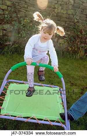Three year old child jumping on a trampoline View Large Photo Image Picture - Three year old child jumping on a trampoline. Fotosearch