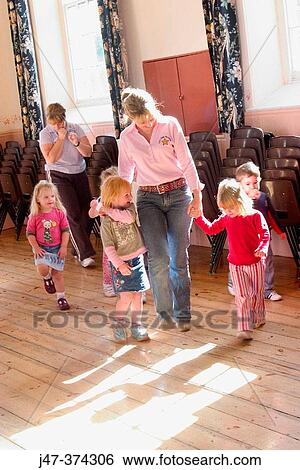 Three year old children at nursrey school dancing with teachers laughing and happy View Large Photo Image Stock Photograph - Three year old children at nursrey school dancing with teachers laughing and happy. Fotosearch