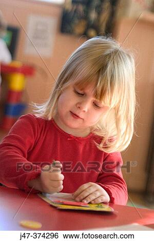 Three year old girl blond hair sitting at table drawing View Large Photo Image Stock Photograph - Three year old girl blond hair sitting at table drawing. Fotosearch