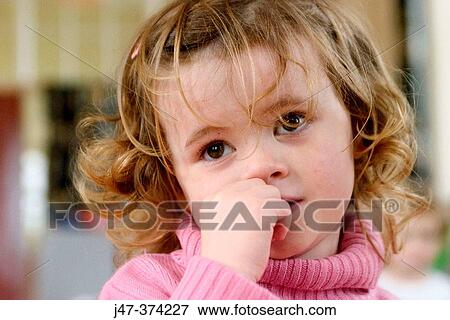 Three year old girl, looking very pensive and worried, at nursrey school View Large Photo Image Stock Photo - Three year old girl, looking very pensive and worried, at nursrey school. Fotosearch