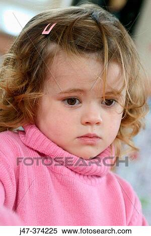 Three year old girl, looking very pensive and worried, at nursrey school View Large Photo Image Stock Photography - Three year old girl, looking very pensive and worried, at nursrey school. Fotosearch