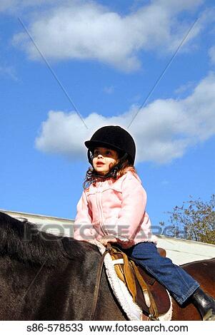 Three year old girl riding a horse, Stanhope Stables, Huntington, NY. View Large Photo Image Stock Image - Three year old girl riding a horse, Stanhope Stables, Huntington, NY.. Fotosearch