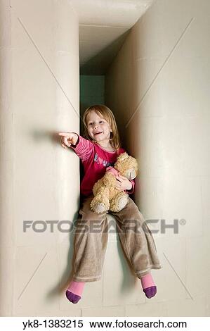 Three Year Old Girl Sitting in Stove Recess Holding Teddy bear and Pointing Hand View Large Photo Image Stock Photography - Three Year Old Girl Sitting in Stove Recess Holding Teddy bear and Pointing Hand. Fotosearch