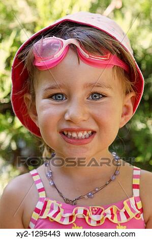 Three year old girl wearing sun hat swimming goggles and swimsuit looking straight at camera and smiling. View Large Photo Image Stock Image - Three year old girl wearing sun hat swimming goggles and swimsuit looking straight at camera and smiling.. Fotosearch
