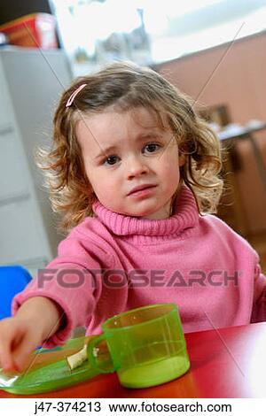 Three year old girl with a plate and cup, looking miserable View Large Photo Image Stock Image - Three year old girl with a plate and cup, looking miserable. Fotosearch