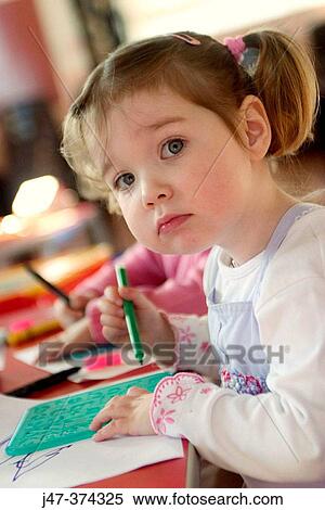 Three year old girl with bunches, drawing at nursrey school View Large Photo Image Stock Photography - Three year old girl with bunches, drawing at nursrey school. Fotosearch