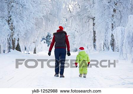 Stock Photo - Three years old girl with mother in snowy parkway. Fotosearch