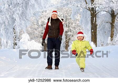 Three years old girl with mother in snowy parkway View Large Photo Image Stock Photograph - Three years old girl with mother in snowy parkway. Fotosearch