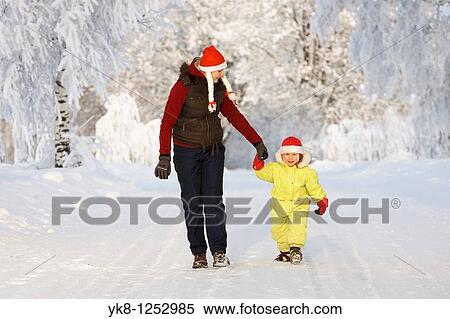 Stock Photography - Three years old girl with mother in snowy parkway. Fotosearch