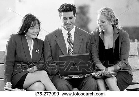 three young businesspeople and wireless laptop View Large Photo Image Stock Photo - three young businesspeople and wireless laptop. Fotosearch
