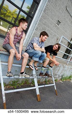 Stock Photography - Three young caucasian males relaxing outdoors in Spokane, Washington, USA.. Fotosearch