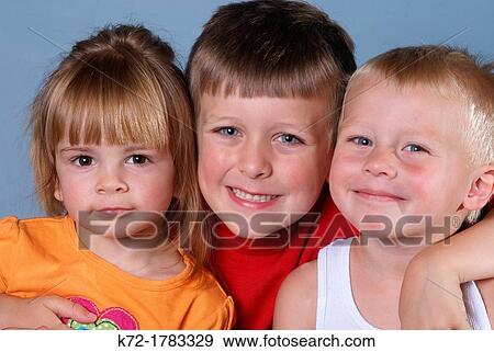 Three youngster posing, each showing different personality, miss independence, trying to please, and little stinker View Large Photo Image Stock Photo - Three youngster posing, each showing different personality, miss independence, trying to please, and little stinker. Fotosearch