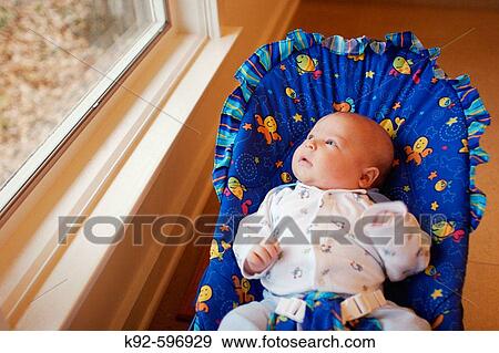 Three_month_old baby looking out a window View Large Photo Image Stock Photo - Three_month_old baby looking out a window. Fotosearch