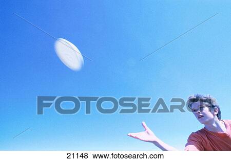 Throwing and catching frisbee View Large Photo Image Stock Photo - Throwing and catching frisbee. Fotosearch