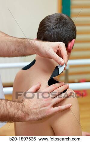 Thumbnail kinesiotaping strips on trapezes to treat contractures Gym, Physiotherapy medical center, Donostia, San Sebastian, Gipuzkoa, Basque Country, Spain View Large Photo Image Stock Photograph - Thumbnail kinesiotaping strips on trapezes to treat contractures Gym, Physiotherapy medical center, Donostia, San Sebastian, Gipuzkoa, Basque Country, Spain. Fotosearch