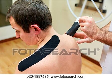 Thumbnail kinesiotaping strips on trapezes to treat contractures Gym, Physiotherapy medical center, Donostia, San Sebastian, Gipuzkoa, Basque Country, Spain View Large Photo Image Stock Photography - Thumbnail kinesiotaping strips on trapezes to treat contractures Gym, Physiotherapy medical center, Donostia, San Sebastian, Gipuzkoa, Basque Country, Spain. Fotosearch