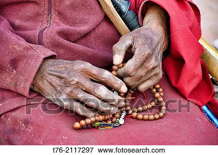 Tibetan pilgrim and prayer beads at the Boudhanath Stupa in Kathmandu, Nepal. View Large Photo Image Stock Photo - Tibetan pilgrim and prayer beads at the Boudhanath Stupa in Kathmandu, Nepal.. Fotosearch
