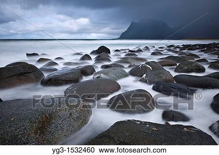 Stock Image - Tidal rock at Utakleiv beach, Vestvagoy, Lofoten islands, Norway. Fotosearch