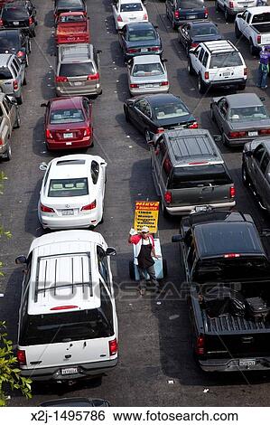 Tijuana, Mexico - As cars wait in long lines to cross the U S -Mexico border into California, a street vendor tries to sell his wares View Large Photo Image Stock Photograph - Tijuana, Mexico - As cars wait in long lines to cross the U S -Mexico border into California, a street vendor tries to sell his wares. Fotosearch