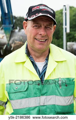 Tilburg, Netherlands. Male employee at Tilburg's garbage company. View Large Photo Image Stock Photograph - Tilburg, Netherlands. Male employee at Tilburg's garbage company.. Fotosearch