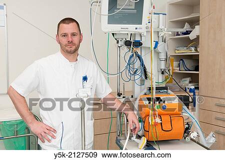 Tilburg, Netherlands. Male paramedic, working in an hospitals trauma room and responsible for respiration related monitoring and trouble shooting. View Large Photo Image Stock Photo - Tilburg, Netherlands. Male paramedic, working in an hospitals trauma room and responsible for respiration related monitoring and trouble shooting.. Fotosearch