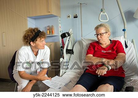 Tilburg, Netherlands. Physio therapist instructing a female post operative patient on how to walk again, after reviving a new hip in surgery. View Large Photo Image Stock Photography - Tilburg, Netherlands. Physio therapist instructing a female post operative patient on how to walk again, after reviving a new hip in surgery.. Fotosearch
