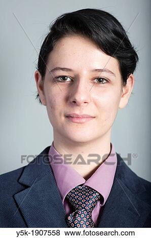 Tilburg, Netherlands Portrait or headshot of a young woman, dressed up as a businessman View Large Photo Image Stock Photo - Tilburg, Netherlands Portrait or headshot of a young woman, dressed up as a businessman. Fotosearch